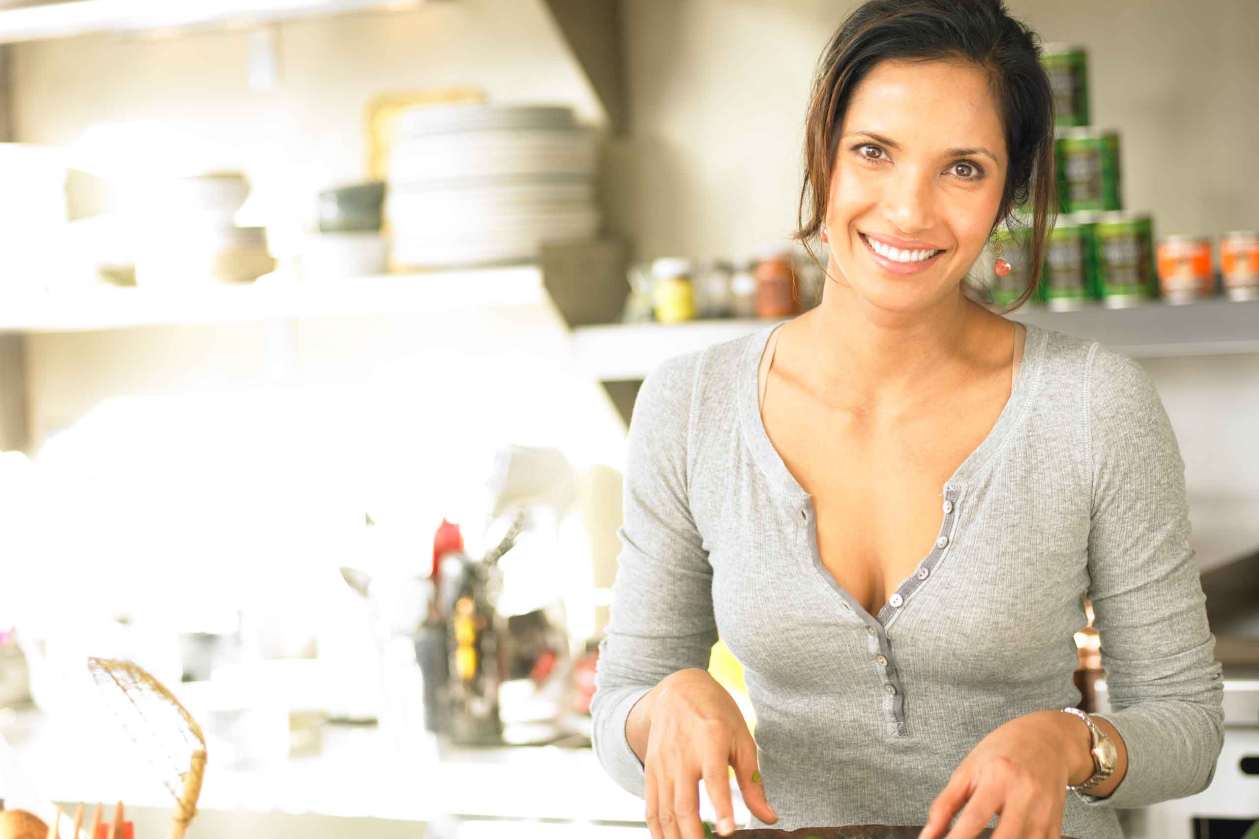 Padma Lakshmi ’92 preparing a meal in a studio kitchen