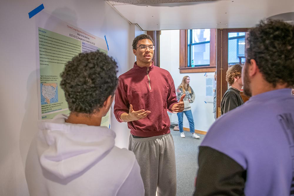 Aedan Derrick discussing his project at an undergraduate research showcase