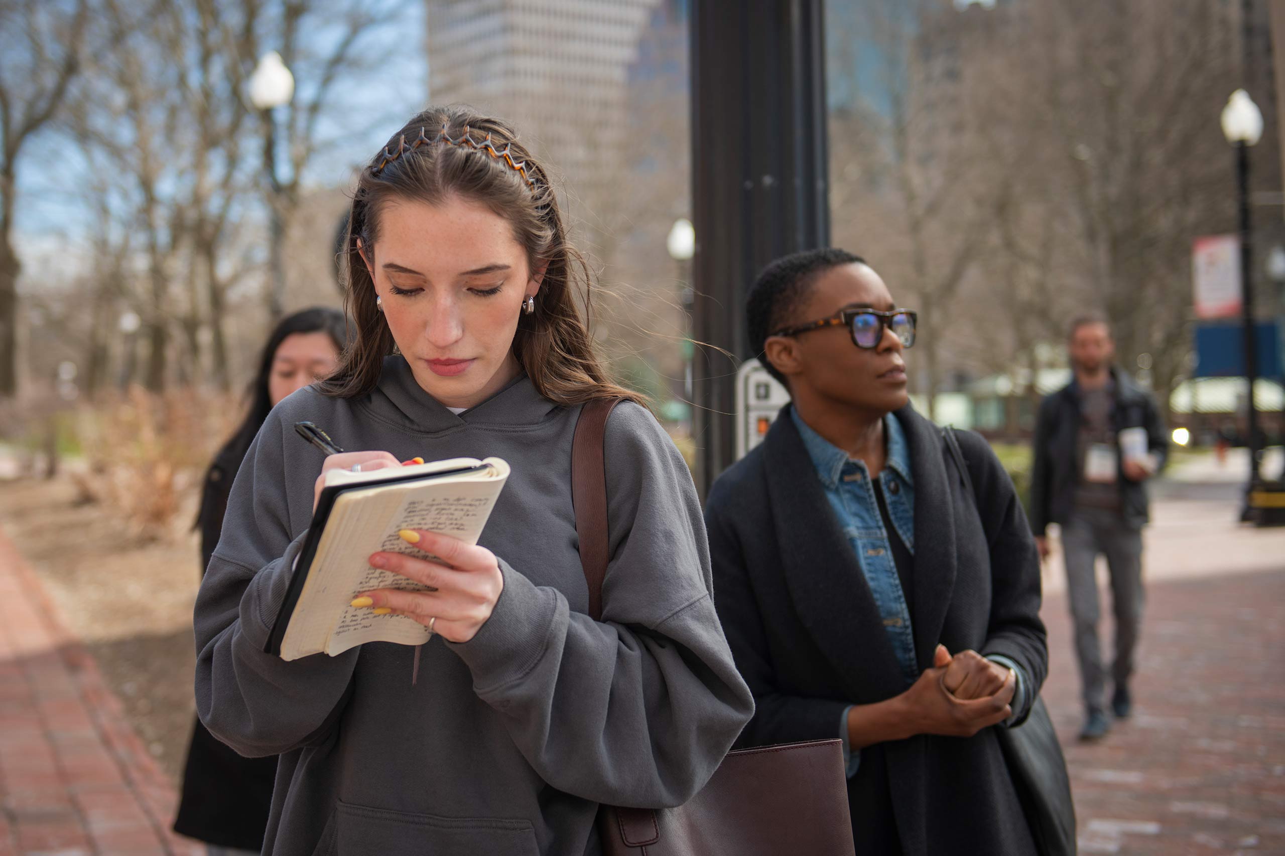 A student takes notes during a field trip to Providence, Rhode Island for an Urban Ethnography Lab