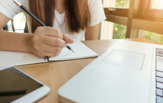 Student writing in notebook