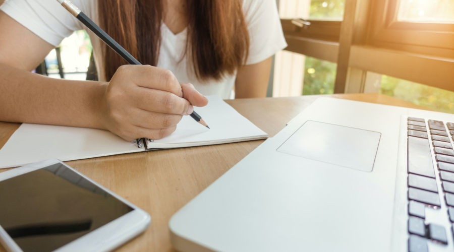 Student writing in notebook