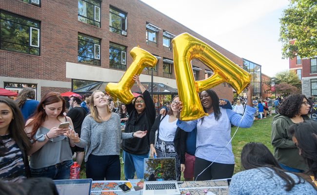 special event outside students holding balloons