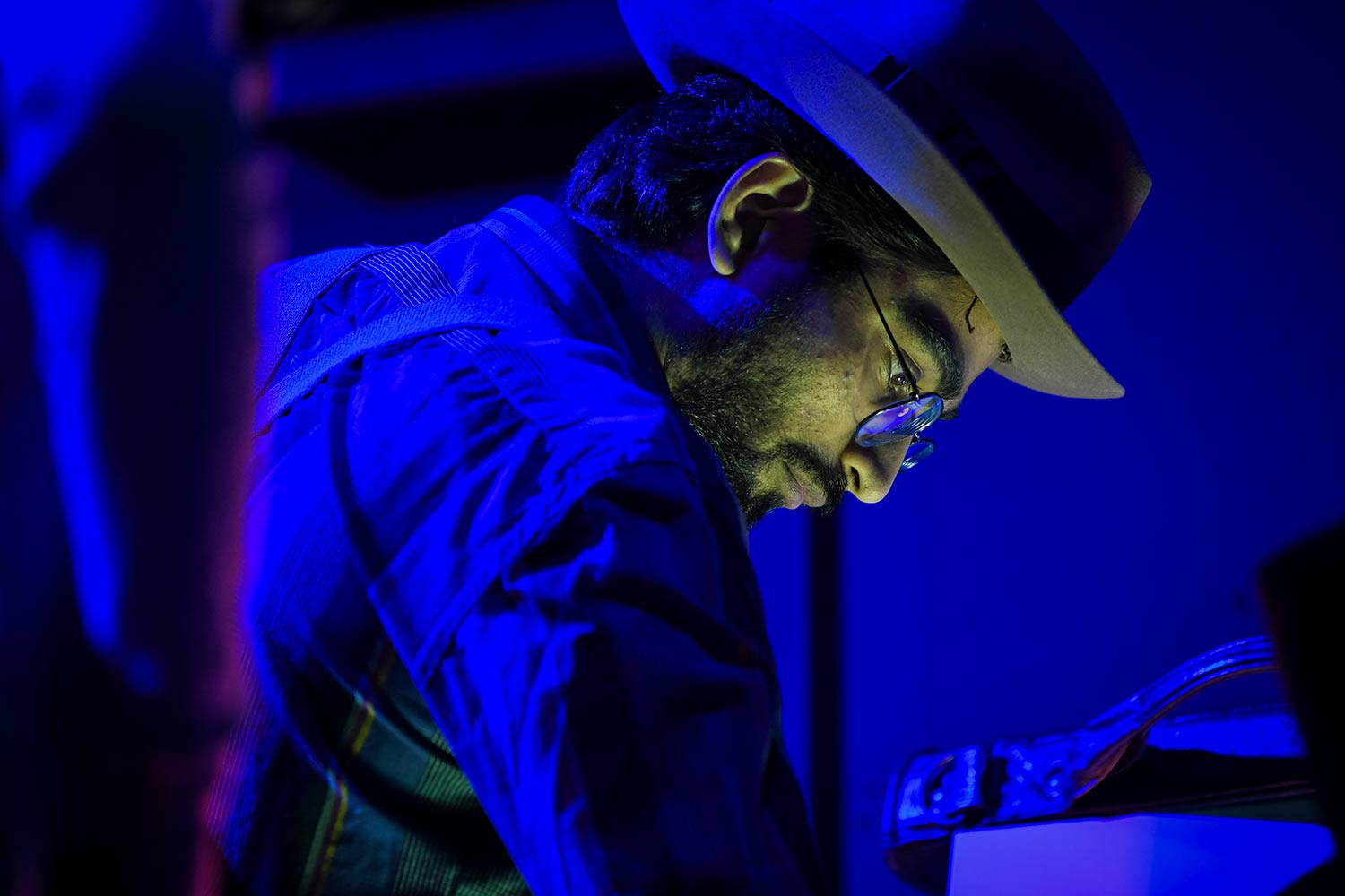 A student stands at a console, dress rehearsal for Hacker’s Ostracon: An Interactive Performance