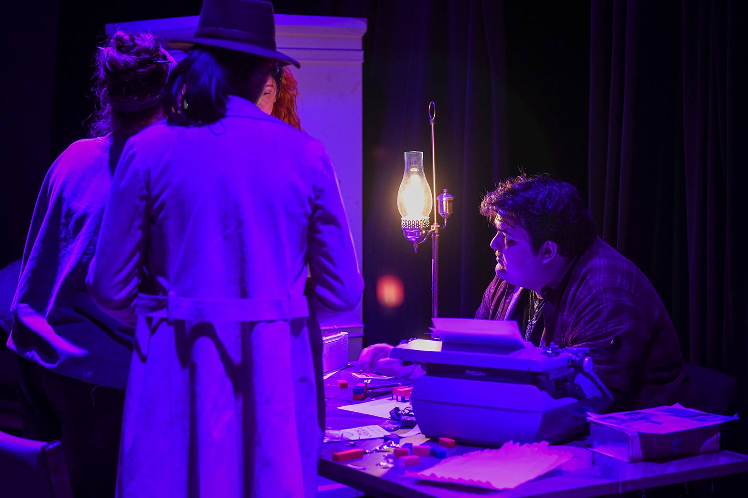 Two students at a table, dress rehearsal for Hacker’s Ostracon: An Interactive Performance