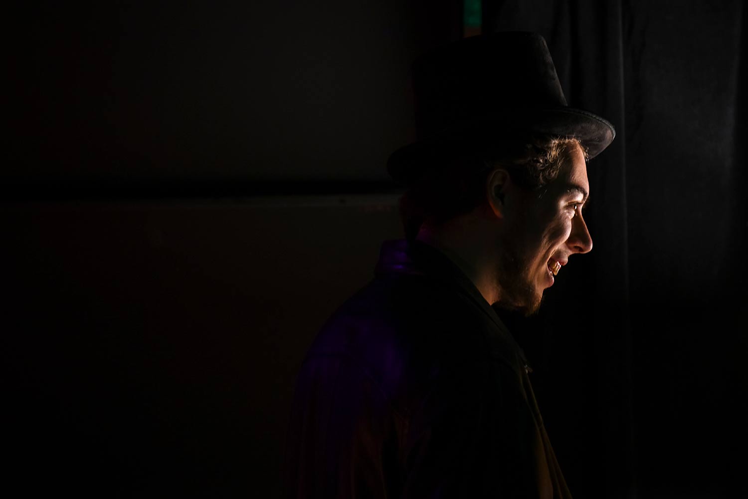 A student smiles, dress rehearsal for Hacker’s Ostracon: An Interactive Performance
