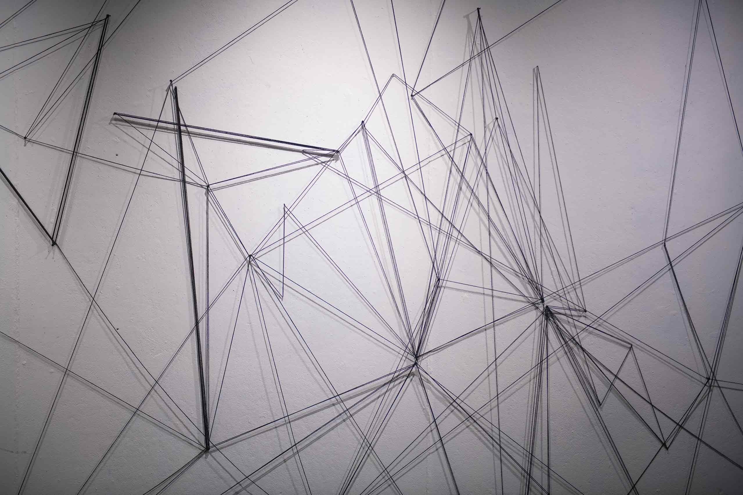 Collaborative wall drawing created by students in studio art Professor Toby Sisson’s course The Expanded Mark, using string and nails.