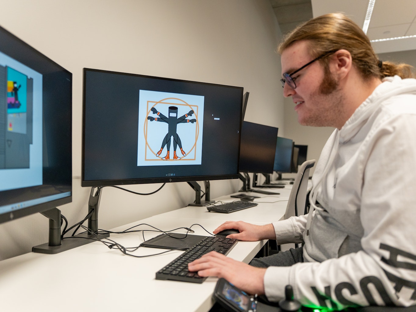 student at computer with art on screen