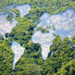 Map of the earth with trees outlining continents showing blue sky