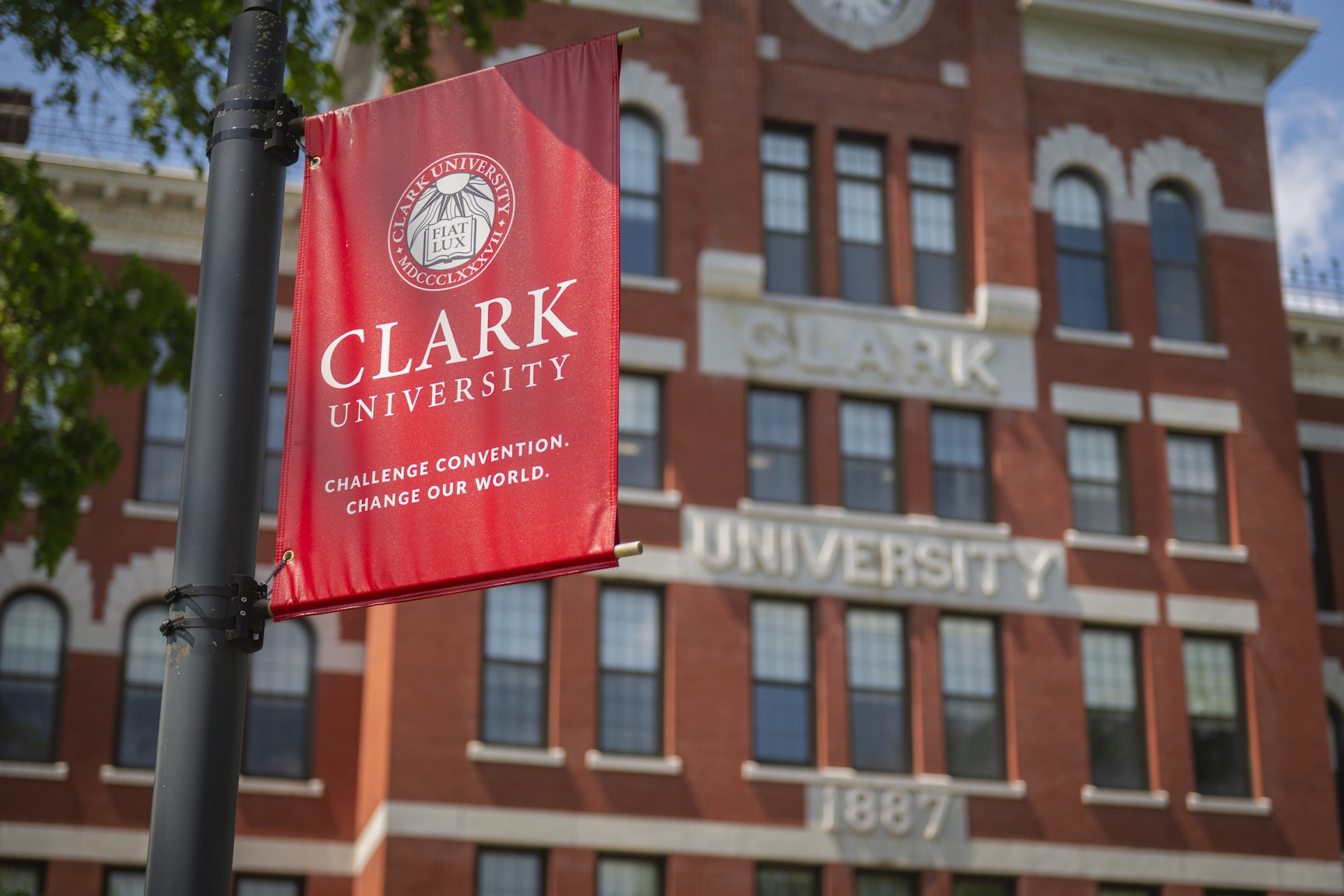 red clark banner hangs in front of jonas clark hall