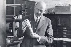 Robert Goddard in his Clark University lab with early steel combustion chamber and nozzle, circa 1920