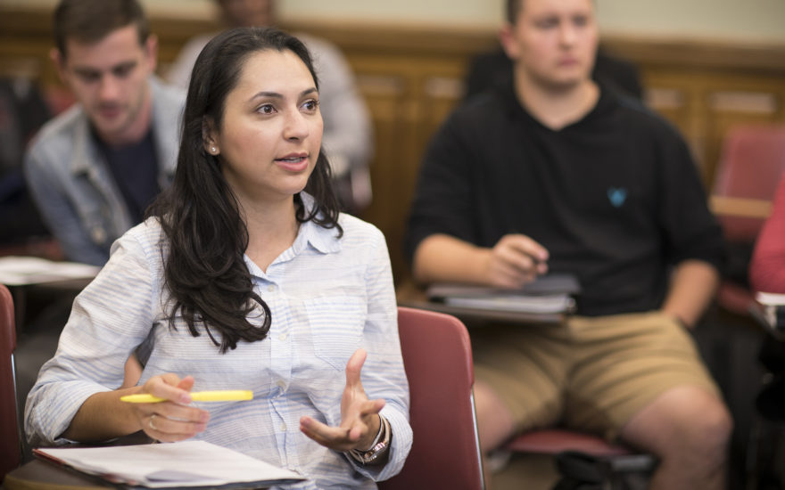 female student talking to professor in clas