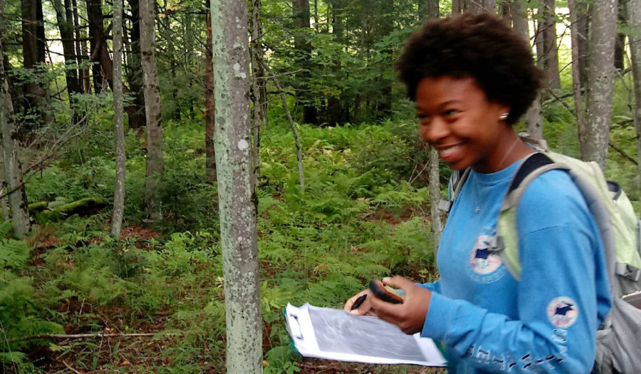 girl with backpack in the woods