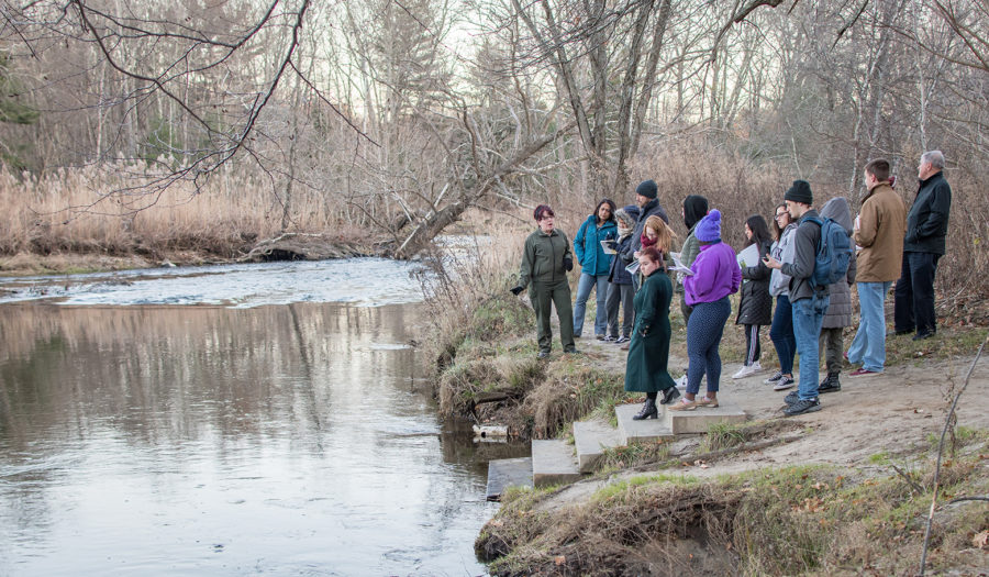 students standing on the edge of a river