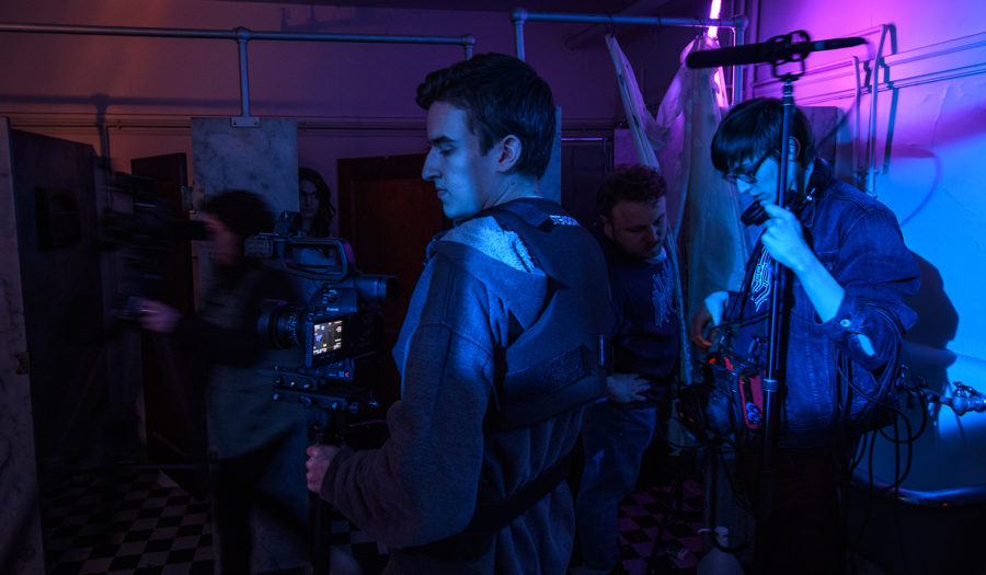 students in dark stage playing instruments