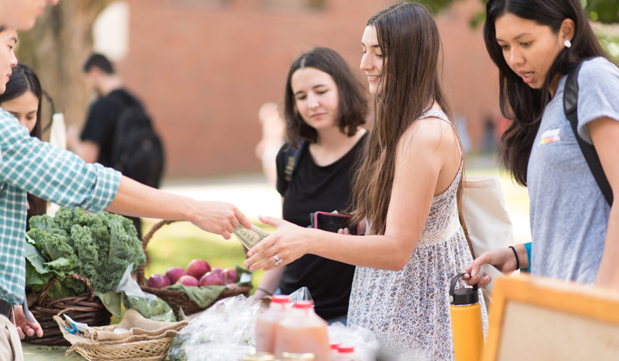 woman buying veggies at market