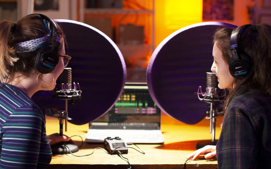 two female students talking into mics in a studio