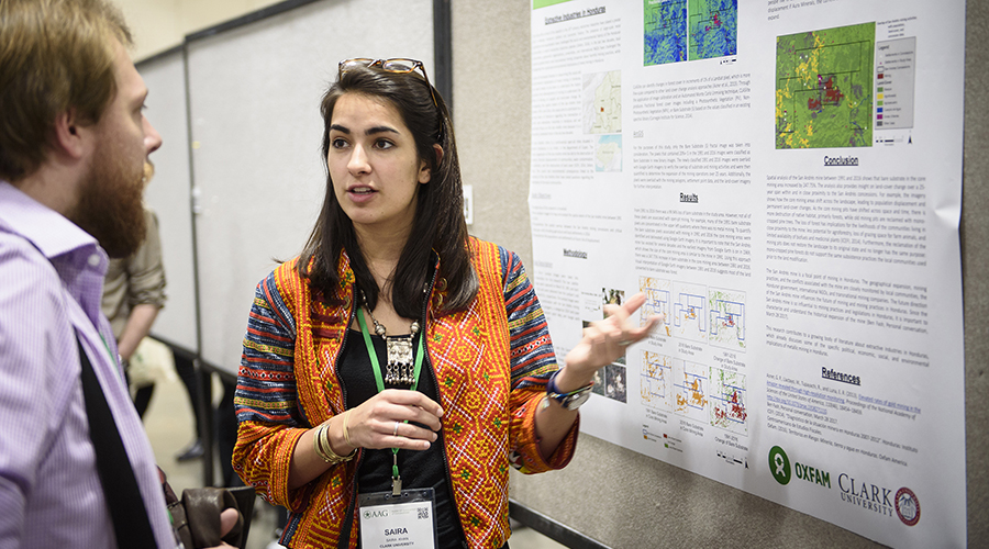 female student looking over poster