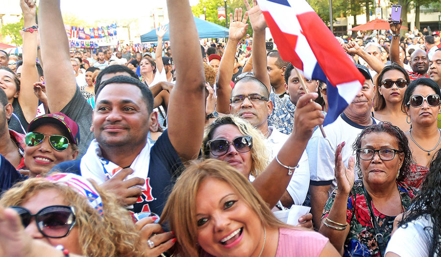 group of puertician citizens holding flag