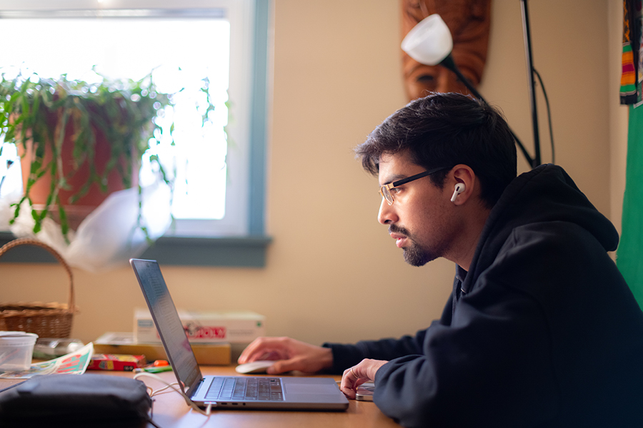 man sitting at laptop