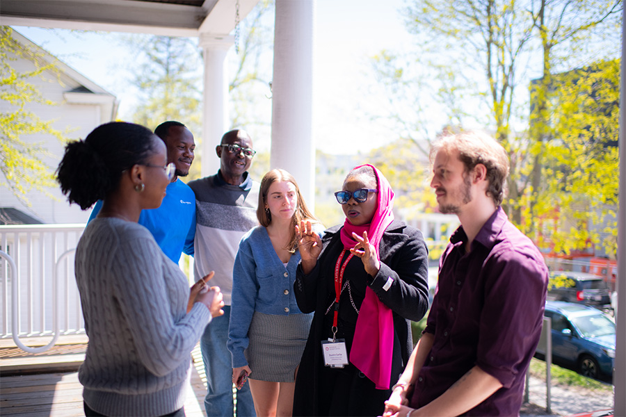 clark students standing on porch discussing issues