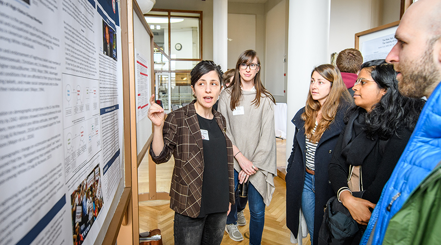 conference setting where student is showing poster.