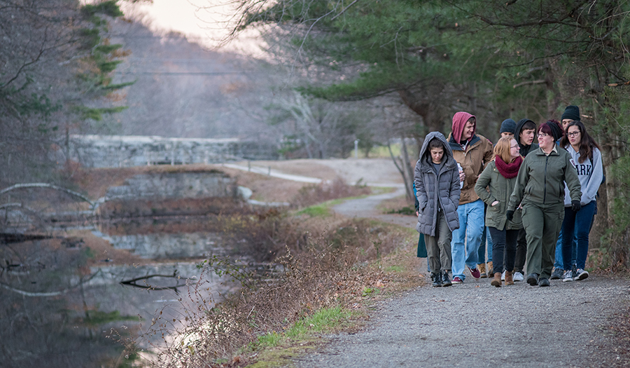 students walking beside river