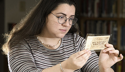 Student looking at old money