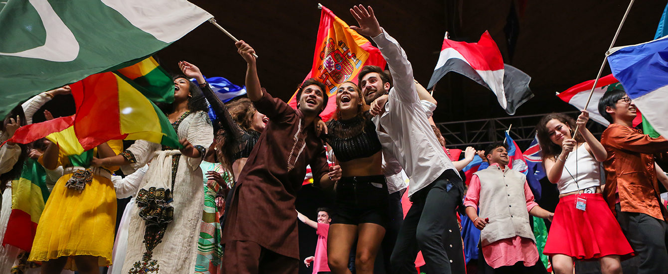 Students on stage waving flags