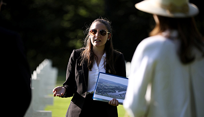 Student talking to people at memorial site