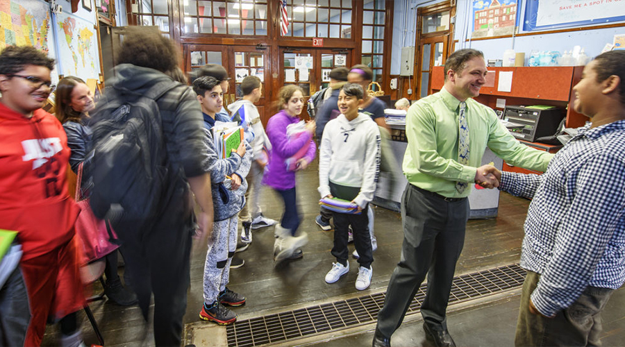 teacher welcoming young students