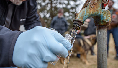 Person getting water out of tap