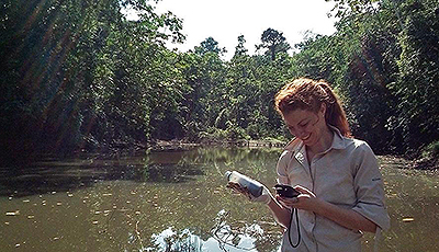 Student measuring near water