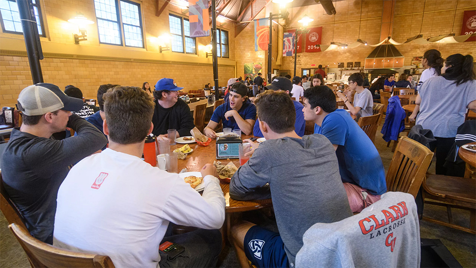 student sitting around dining hall