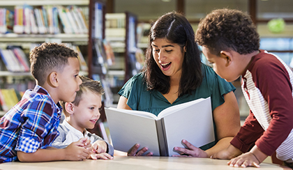 teacher reading to young students