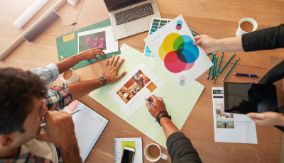 marketing majors reviewing marketing assets on desk