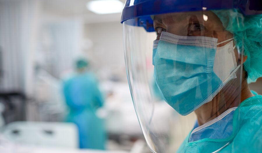 Doctor with face shield and face mask in hospital