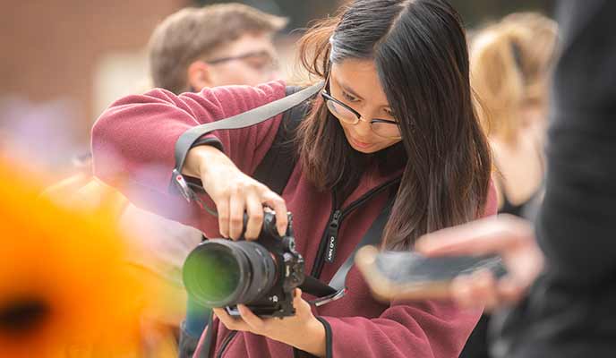 Natalie Hoang ’25, MBA ’26, takes photos at the Clark Collective Wednesday Pop-up.