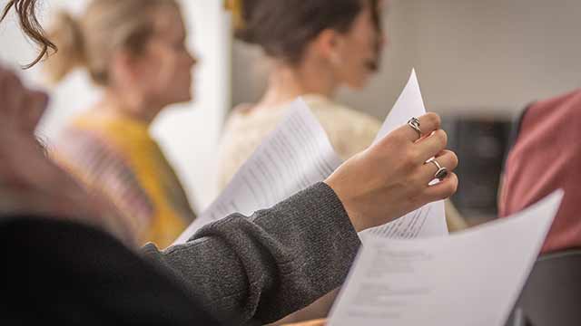 a student handles papers in class