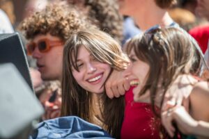 Students share a laugh during an outdoor concert at Clark's annual Spree Day.