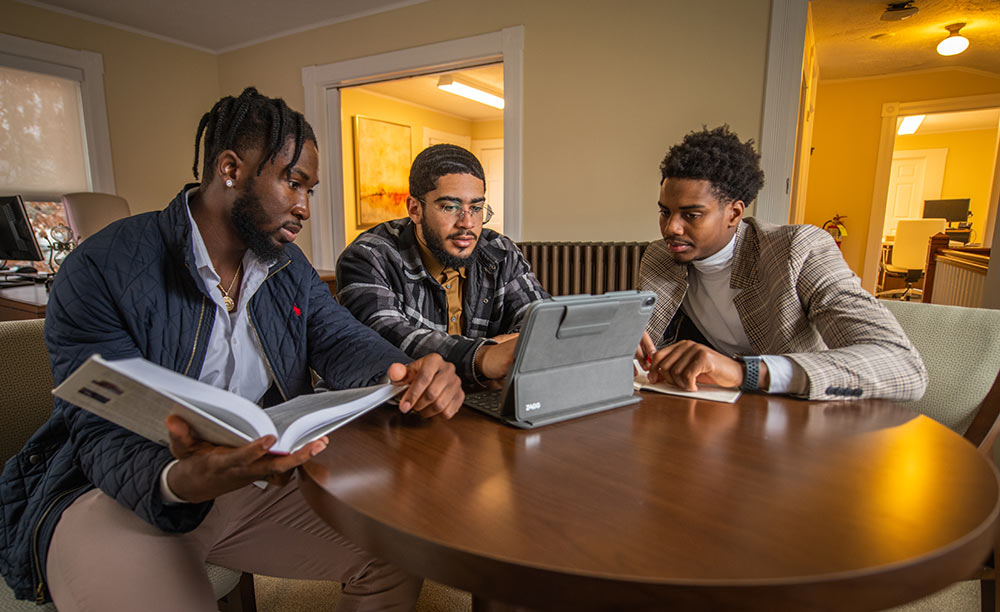 Three Mosakowski interns work collaboratively at the Institute