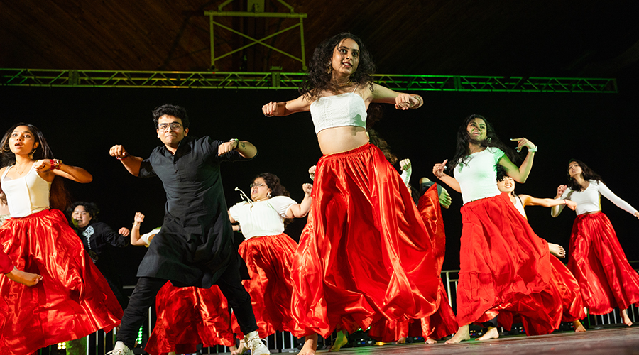 Group of students dancing on stage at international gala