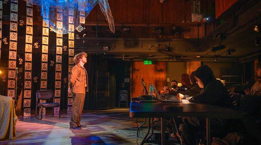 Student rehearsing song for a play in the theater