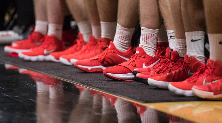 Line of mens basketball shoes along bench