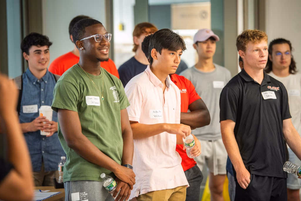 Computer science students listening to alumni present at a networking event