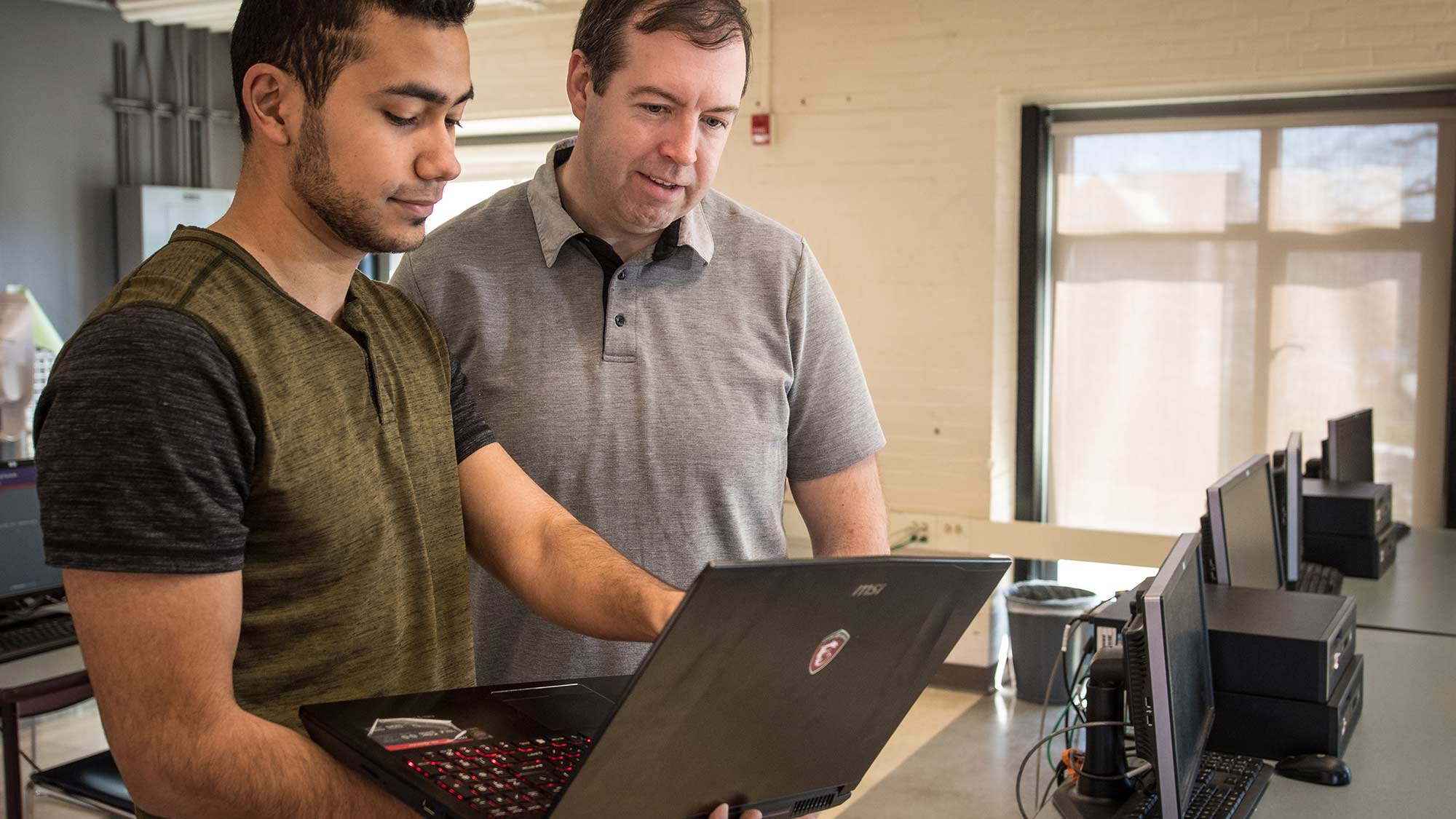 John Magee helping a computer science student on their project
