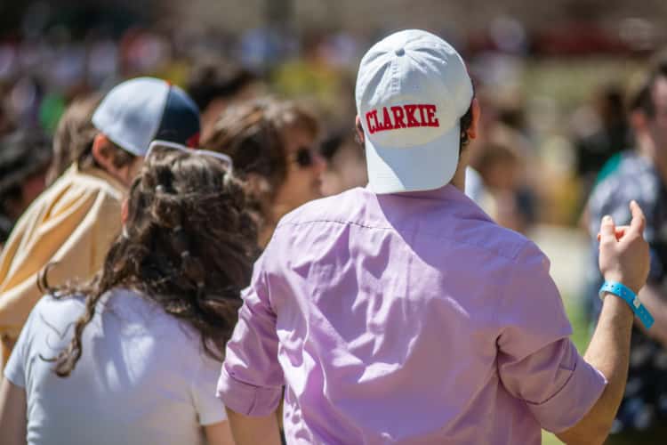 a student wearing a cap that reads, 