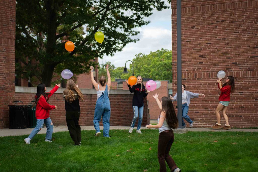 A Navigatory cohort participates in an outdoor balloon activity during orientation