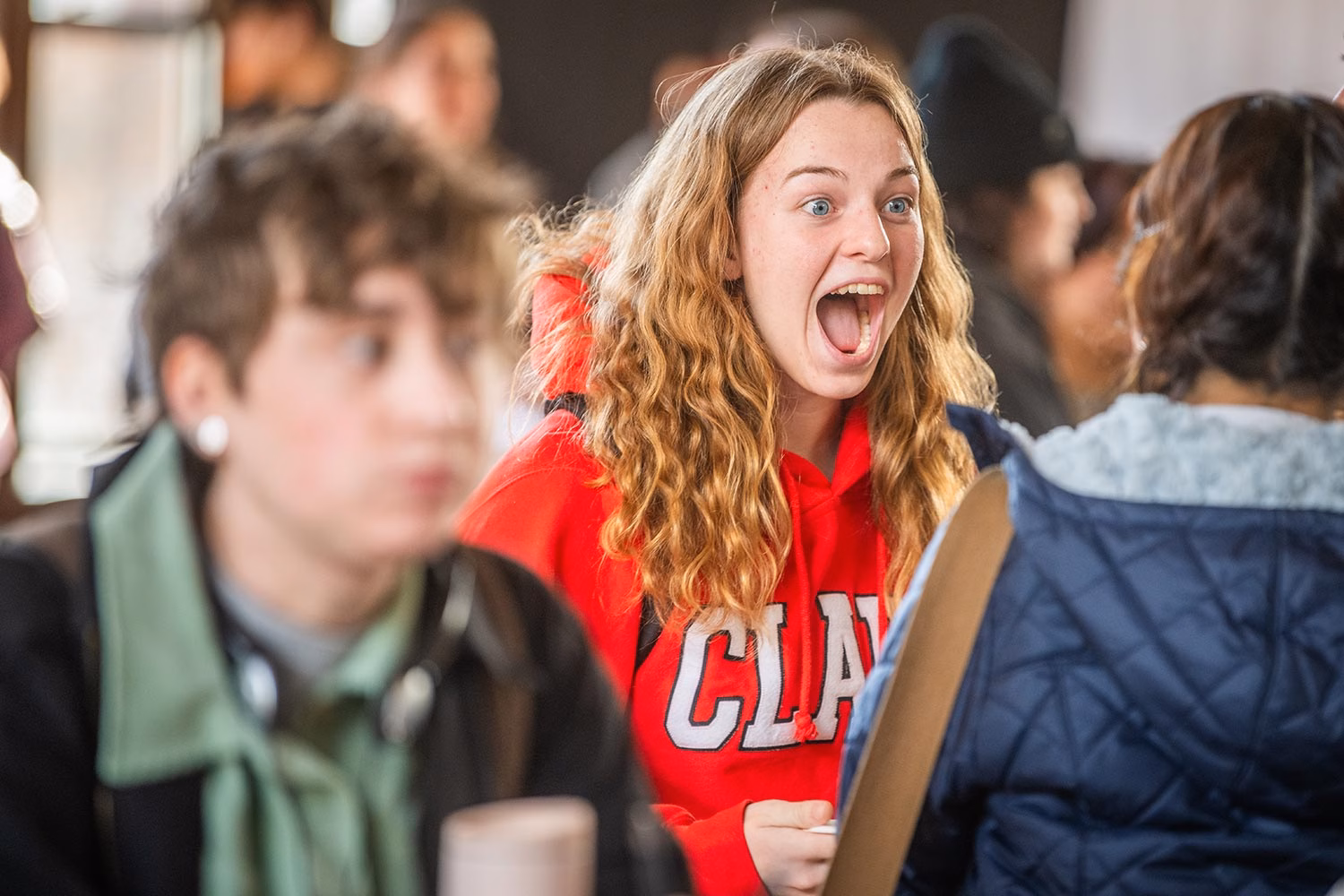 Students interact in an excited way during a Navigator event