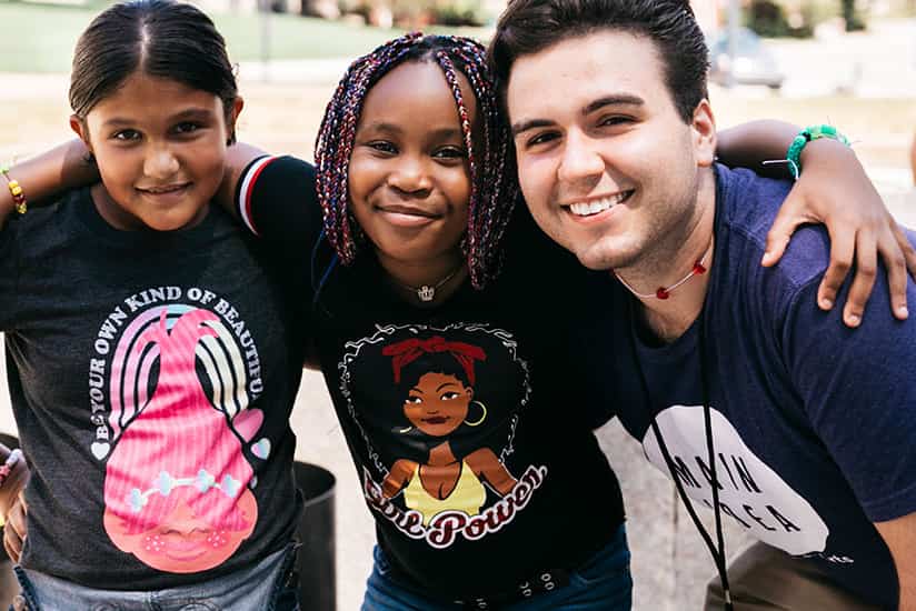 a Clark education student with his students