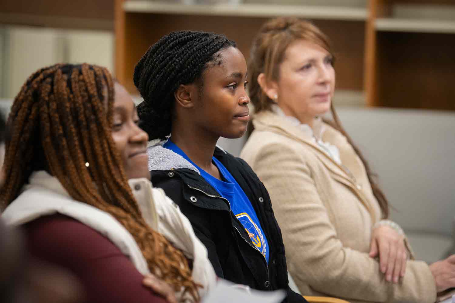 Students, faculty, and members of the Worcester community gather for a signing ceremony to mark a partnership between Clark University and African Community Education (ACE), a Worcester agency that works to help African refugee and immigrant youth and families achieve educational and social stability.